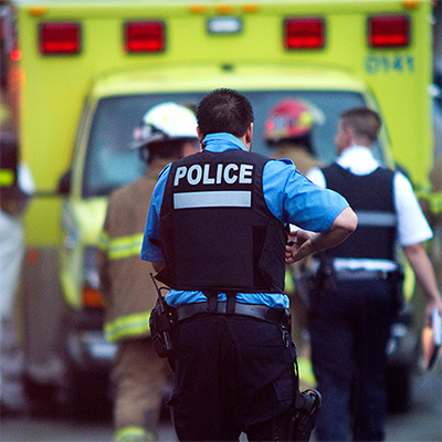 Emergency personnel in front of an ambulance.